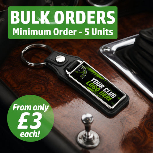 Personalised wide rectangle leather and metal car club keyring on a classic car centre console featuring text for bulk wholesale orders.