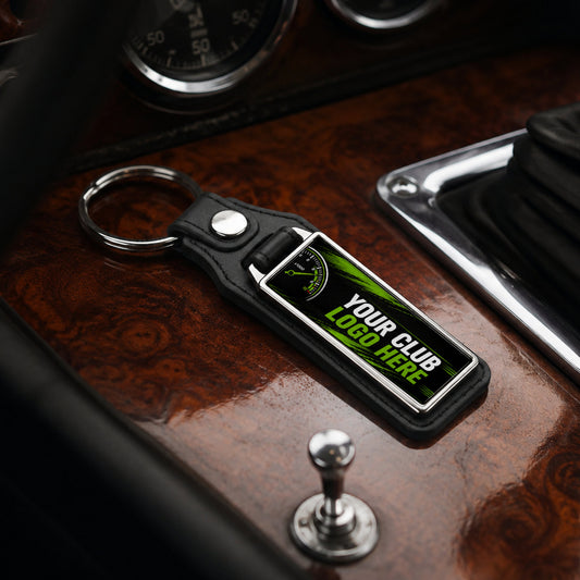 Personalised long rectangle leather and metal car club keyring on a classic car centre console.