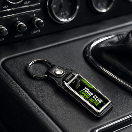 Personalised long rectangle leather and metal car club keyring on a modern car centre console.