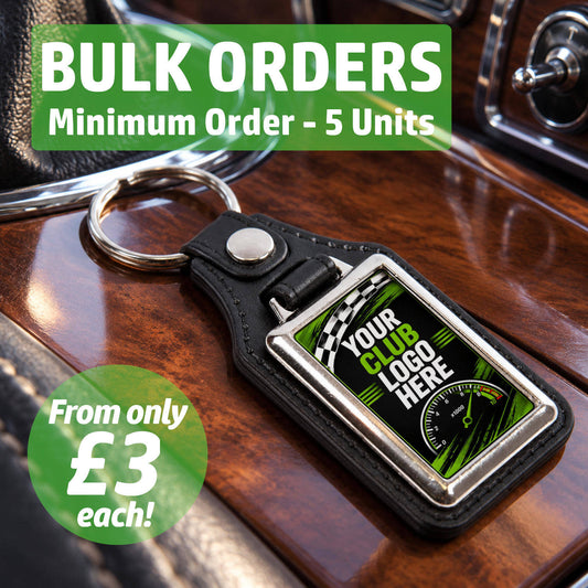 Personalised rectangle leather and metal car club keyring on a classic car centre console featuring text for bulk wholesale orders.