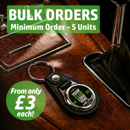 Personalised round rectangle leather and metal car club keyring on a classic car centre console featuring text for bulk wholesale orders.