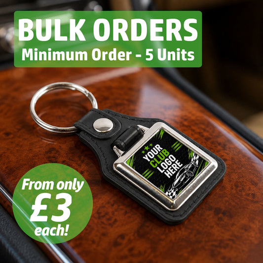 Personalised square leather and metal car club keyring on a classic car centre console featuring text for bulk wholesale orders.