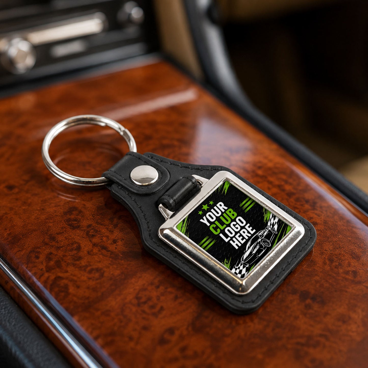 Personalised square leather and metal car club keyring on a classic car centre console.